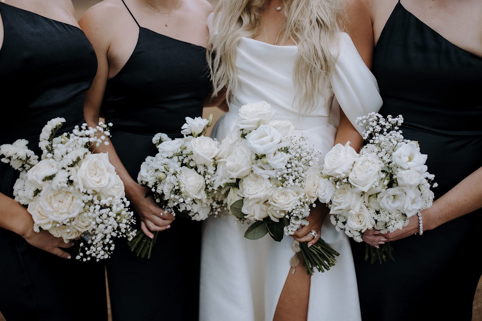 Real Wedding - Brittany + Edward - Bimbadgen Palmers Lane, Hunter Valley - The Beginning Studio - bride and bridesmaids holding up flowers